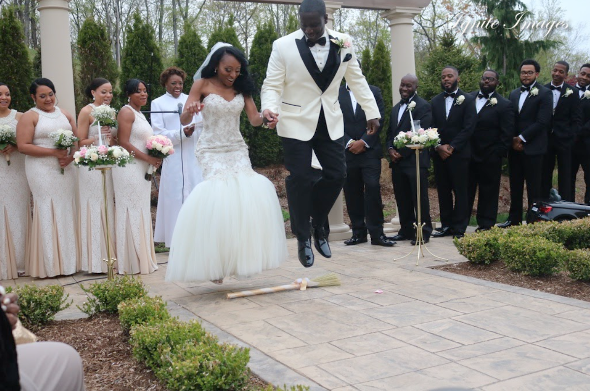 couple jumping broom