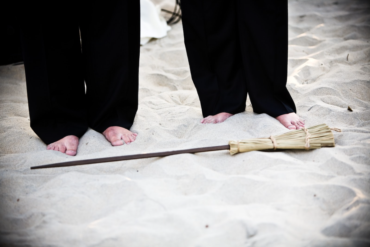 couple jumping broom