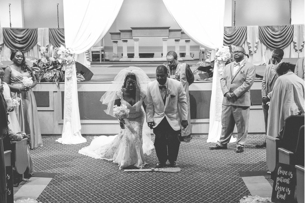 couple jumping broom