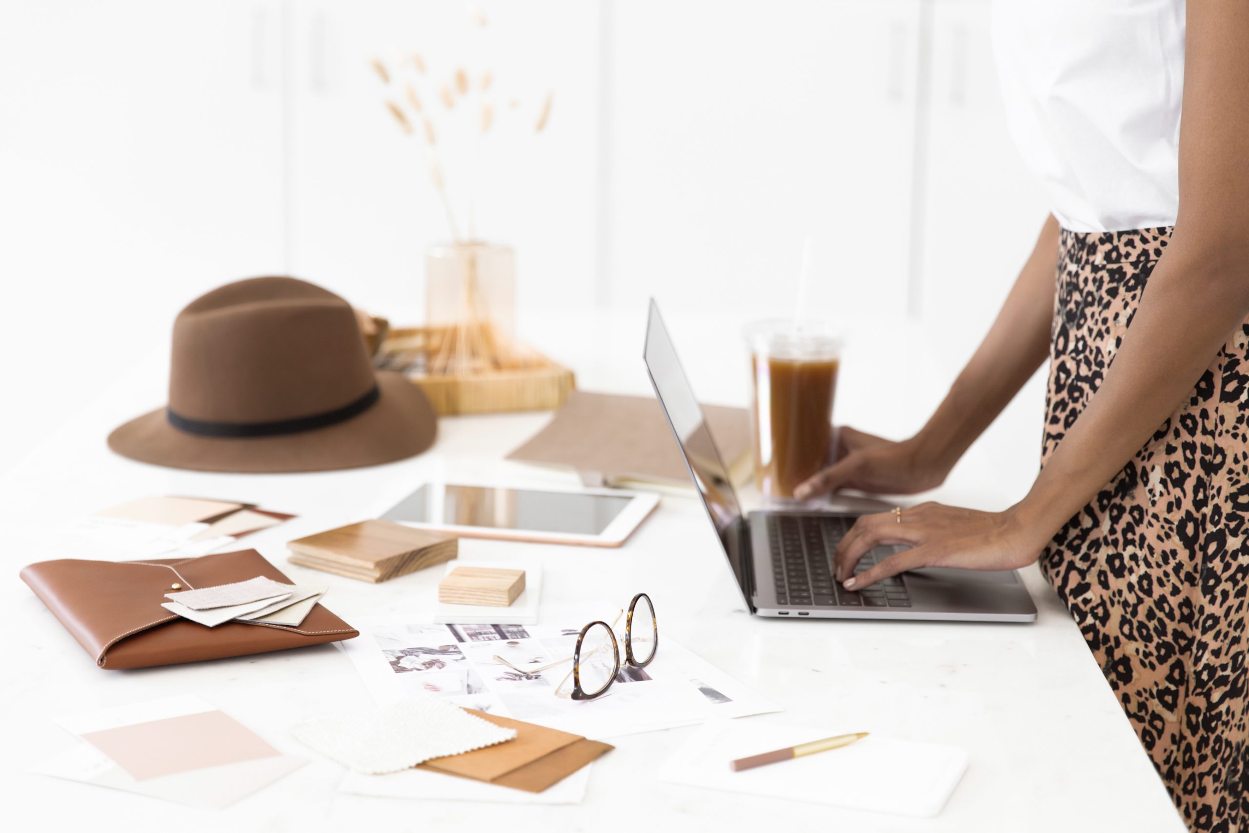 A work desk with a laptop and papers on it
