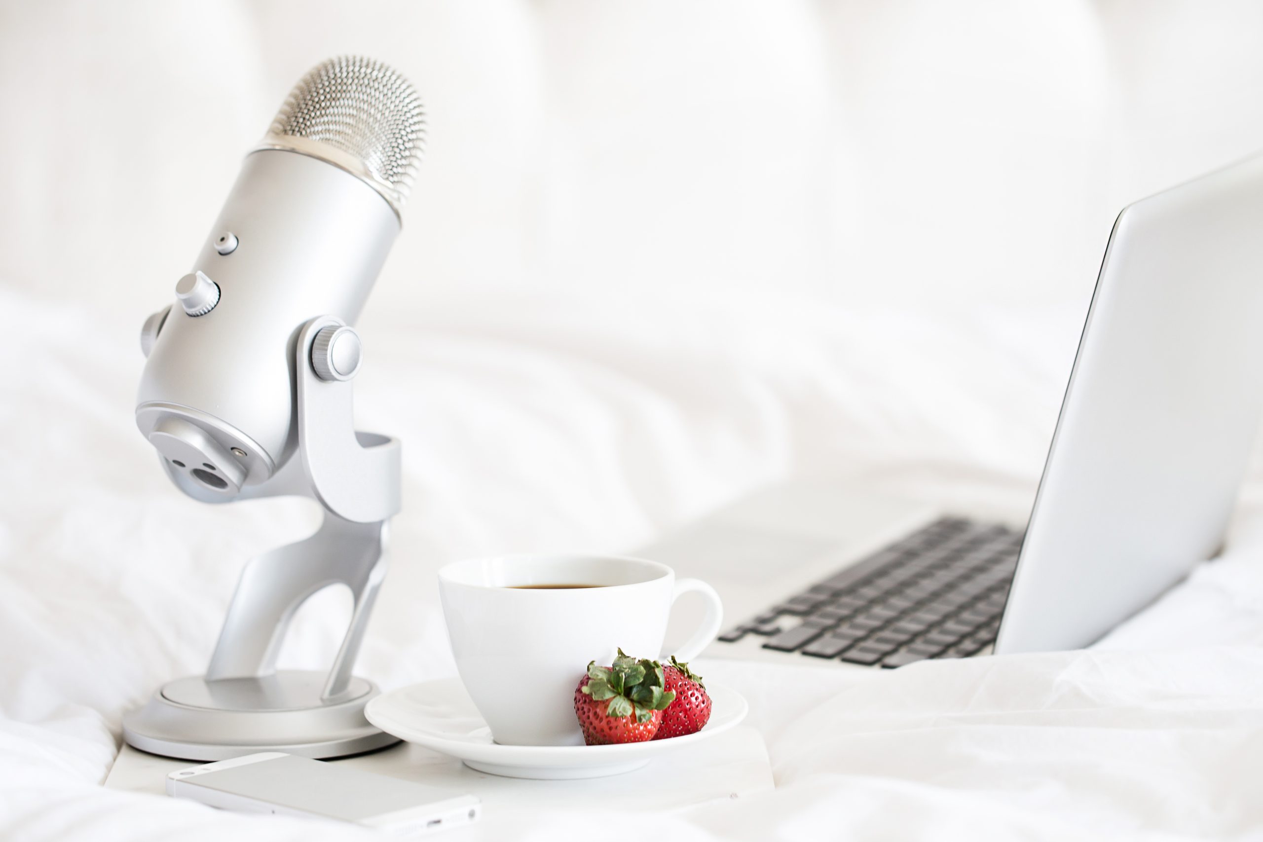 Mic and laptop on a bed
