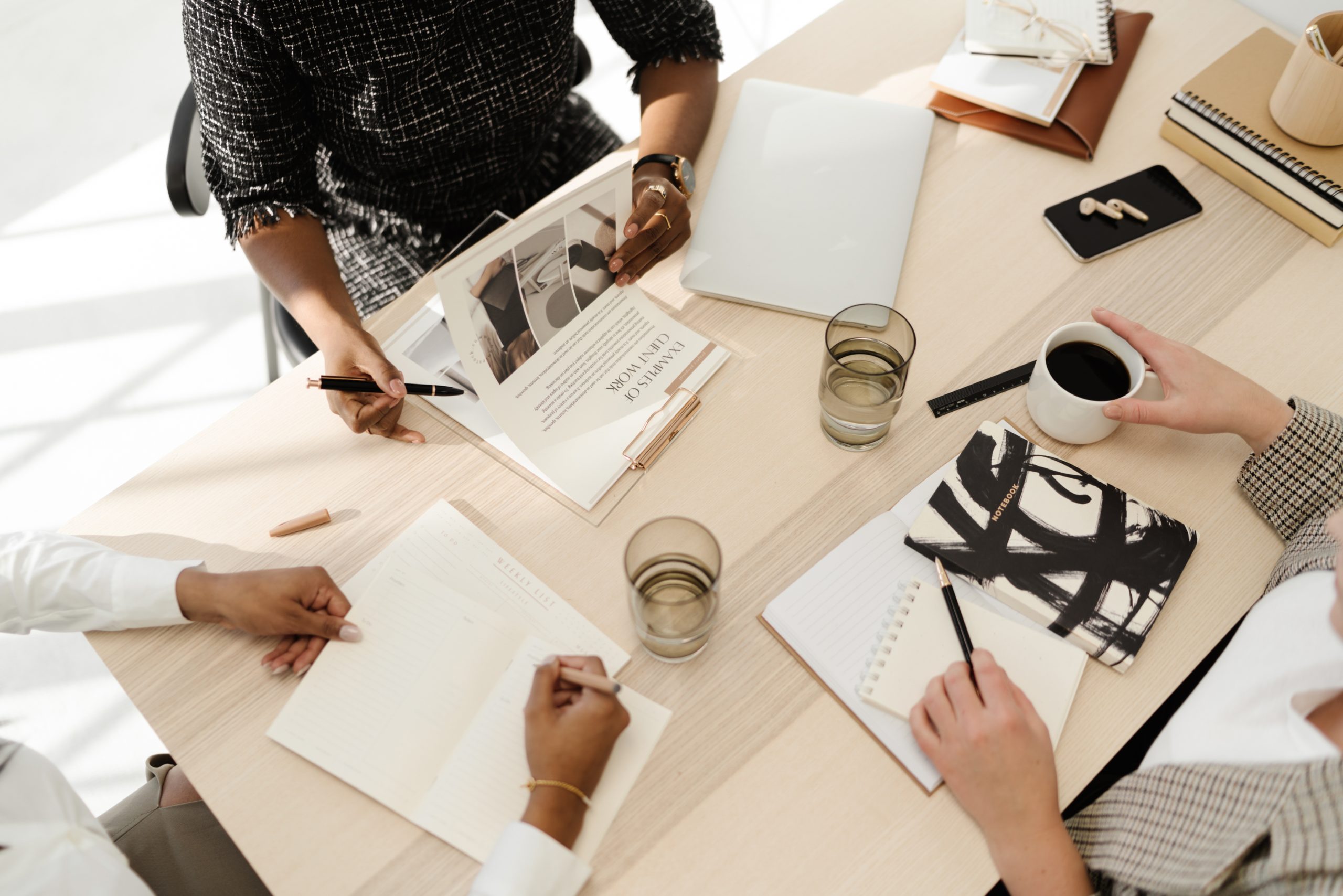 A table with a team working. Papers and lap tops featured.