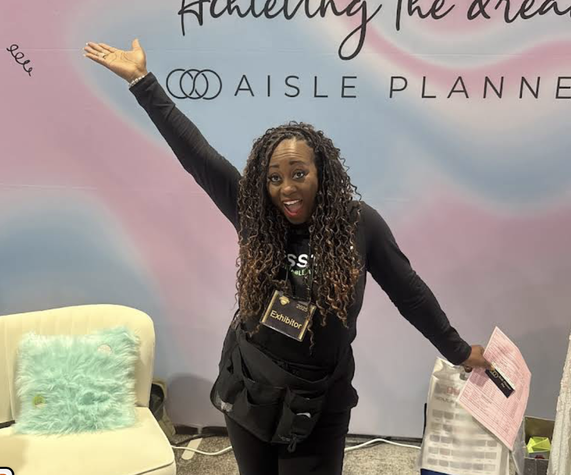 planner A professional wedding planner smiles while engaging at the Wedding MBA convention booth, showcasing their support for Aisle Planner Pro as their preferred all-in-one event management software and business suite.