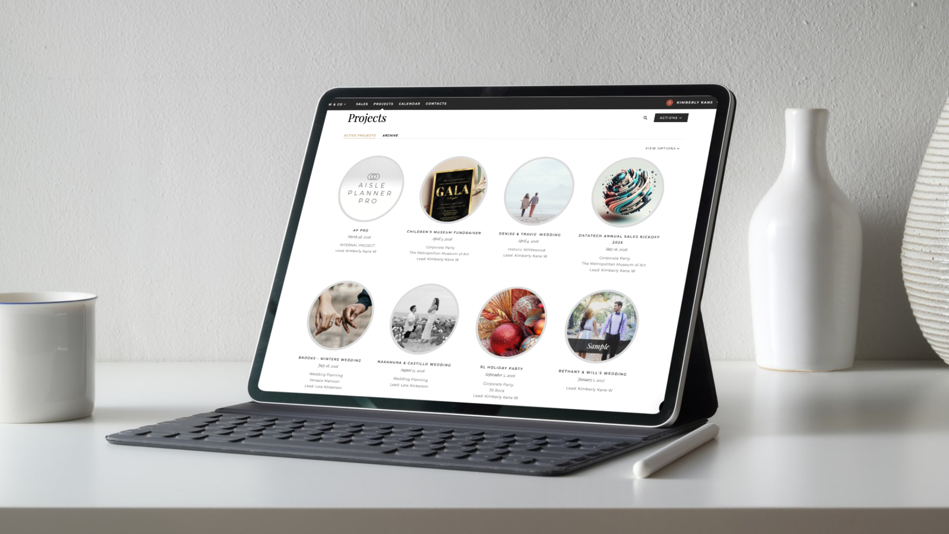 A professional wedding planner uses a laptop to manage multiple client projects on the Aisle Planner Pro dashboard, streamlining event coordination through an organized digital workspace.
