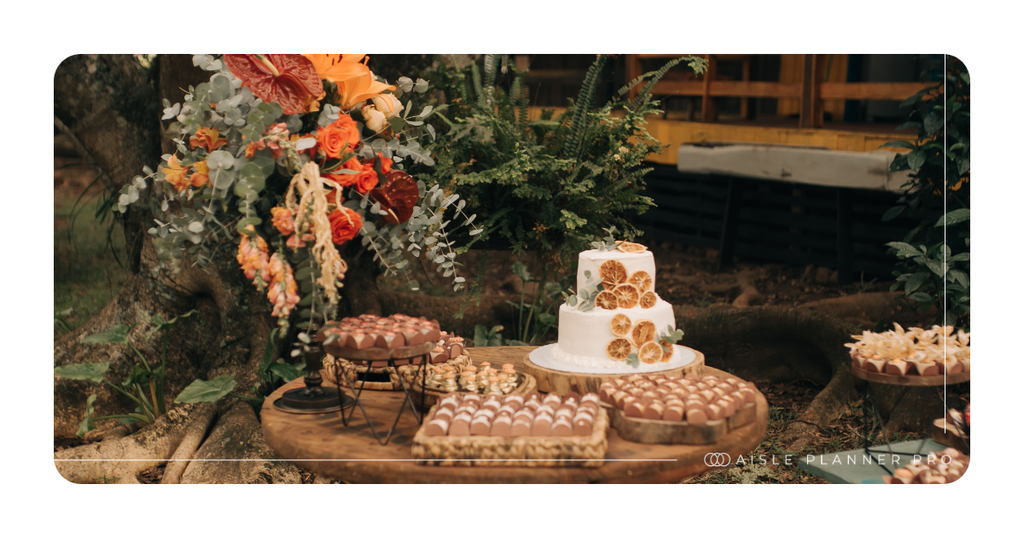 Fall wedding dessert table with tiered cake, seasonal florals and styled décor for professional wedding and event planning.