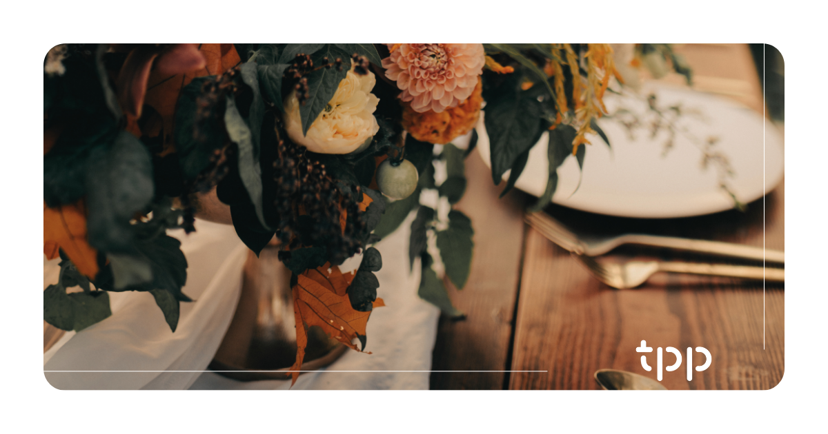 Moody fall wedding floral arrangement and elegant table setting for professional catering and event planning with Total Party Planner.