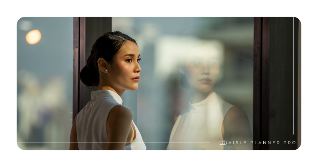 Venue professional overlooking a modern venue through floor-to-ceiling windows, reflecting the elegance, creativity, and thoughtful details behind exceptional event planning.